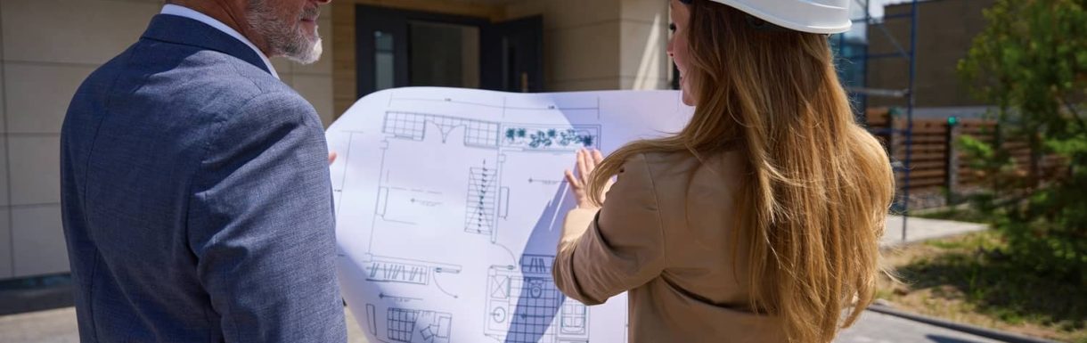 realtor-woman-looks-over-blueprint-with-a-client-i-2025-03-10-05-42-34-utc